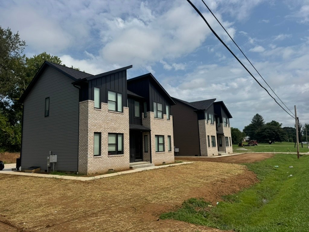 Home Residential buildings with brick exteriors and dark siding